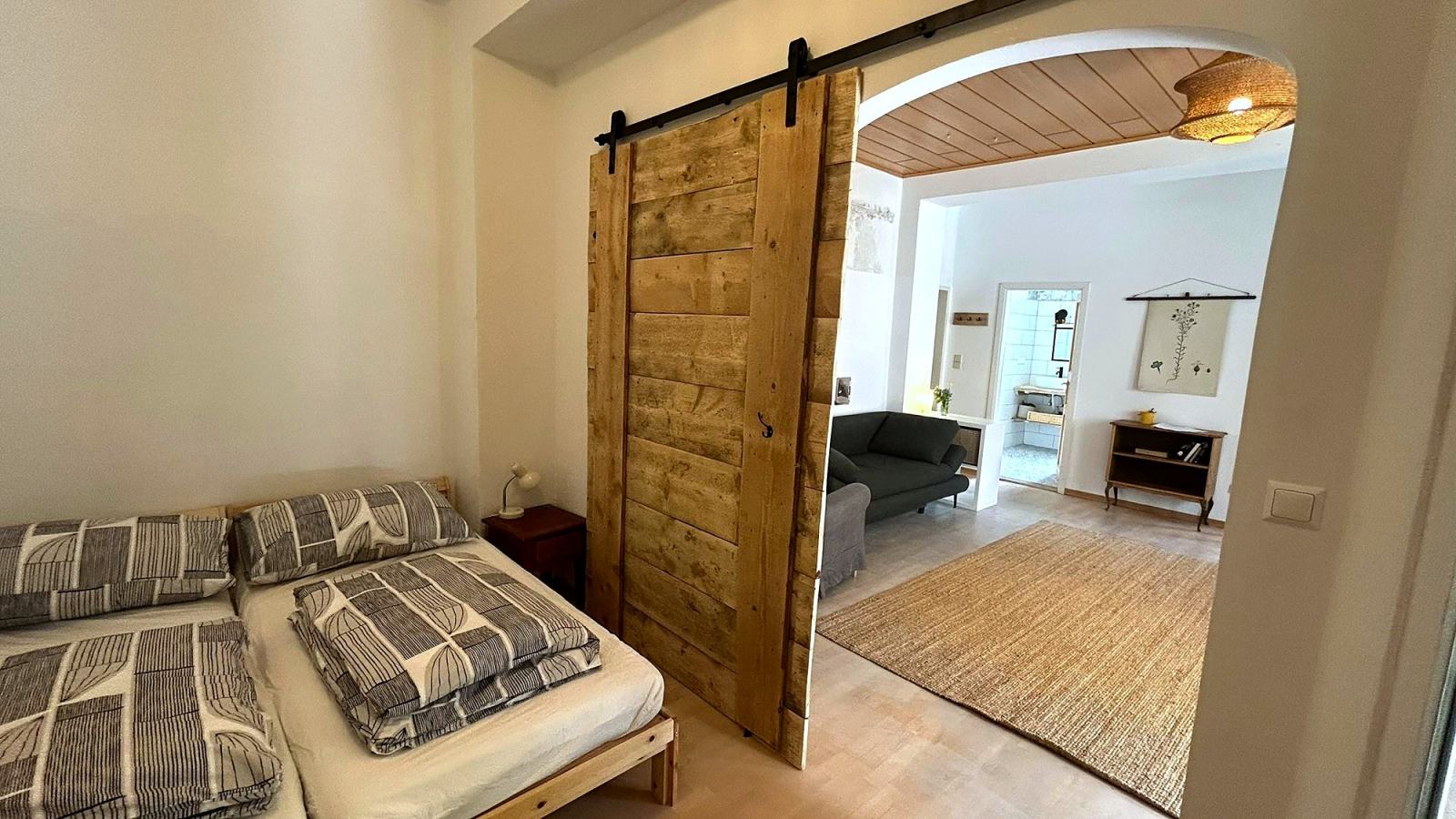 Schlafbereich der Gartenwohnung hinter der Schiebetür